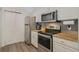 Stainless steel appliances and granite countertops at 142 Southern Pecan Cir # 207, Winter Garden, FL 34787