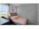 Bedroom with full bed, window and moon wall art at 1672 Hummingbird Rd, Winter Haven, FL 33884