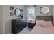 Bright bedroom with a pink bedspread and a dresser at 1672 Hummingbird Rd, Winter Haven, FL 33884