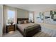 Main bedroom with wood-look floors and large windows at 1672 Hummingbird Rd, Winter Haven, FL 33884
