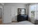 Black dresser and mirror in a bedroom at 1672 Hummingbird Rd, Winter Haven, FL 33884