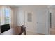 Bright home office with wood desk and access to bathroom at 1672 Hummingbird Rd, Winter Haven, FL 33884