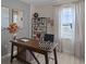 Bright home office features a large desk, built-in shelving, and a view at 1672 Hummingbird Rd, Winter Haven, FL 33884