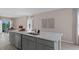 Modern kitchen with gray cabinets, quartz countertops and stainless steel appliances at 1680 Hummingbird Rd, Winter Haven, FL 33884