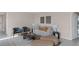 Living room with beige couch, two teal armchairs and a round coffee table at 1680 Hummingbird Rd, Winter Haven, FL 33884
