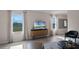 Bright living room features wood-look floors and large windows at 1680 Hummingbird Rd, Winter Haven, FL 33884