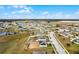 Wide aerial shot reveals the home's proximity to neighborhood amenities and surrounding landscaping at 1952 Piedmont Ct, Mascotte, FL 34753