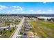 Aerial view showcasing home's location in a residential neighborhood near a lake at 1952 Piedmont Ct, Mascotte, FL 34753