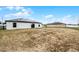 Back view of home with solar panels, sliding glass door, and big backyard at 1952 Piedmont Ct, Mascotte, FL 34753