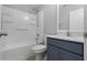 Cozy bathroom with shower-tub combo, framed mirror, and modern sink at 1952 Piedmont Ct, Mascotte, FL 34753
