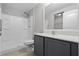 This bathroom features a shower and vanity with white countertops at 1952 Piedmont Ct, Mascotte, FL 34753