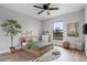 This bedroom is decorated in earth tones and features a ceiling fan and wood floors at 1952 Piedmont Ct, Mascotte, FL 34753