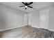This bedroom features wood floors and a ceiling fan at 1952 Piedmont Ct, Mascotte, FL 34753