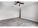 This bedroom features wood floors and a ceiling fan at 1952 Piedmont Ct, Mascotte, FL 34753
