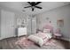 This cute bedroom is decorated in pink tones and features wood floors at 1952 Piedmont Ct, Mascotte, FL 34753