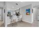 Breakfast bar featuring two cushioned stools and open view to the eat-in kitchen at 1952 Piedmont Ct, Mascotte, FL 34753