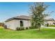 Exterior view of a single-story home showing the lawn, landscaping, and architectural design elements at 1952 Piedmont Ct, Mascotte, FL 34753