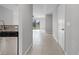 View of home hallway with tile flooring, leading to an open living space at 1952 Piedmont Ct, Mascotte, FL 34753