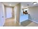 Hallway featuring tile flooring, leading into the kitchen with breakfast bar at 1952 Piedmont Ct, Mascotte, FL 34753