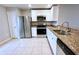 Kitchen featuring stainless steel appliances, white cabinets, and granite countertops at 1952 Piedmont Ct, Mascotte, FL 34753