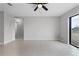 This spacious living room offers tile floors, ceiling fan, and a view to the backyard at 1952 Piedmont Ct, Mascotte, FL 34753