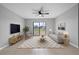 Bright living room featuring stylish furniture, a ceiling fan, and sliding glass doors at 1952 Piedmont Ct, Mascotte, FL 34753