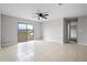 This living room features tile floors, a ceiling fan and sliding glass doors to the backyard at 1952 Piedmont Ct, Mascotte, FL 34753