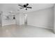 This open floorplan features tile floors, ceiling fans, and an open view to the kitchen at 1952 Piedmont Ct, Mascotte, FL 34753