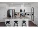 Modern kitchen with white cabinets, granite countertops and stainless steel appliances at 2785 Flushing Dr, Apopka, FL 32703