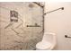 Modern bathroom with marble-look walls, glass shower, and pebble floor at 2932 Carriage Dr, Daytona Beach, FL 32119