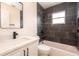Updated bathroom with dark tile shower, white vanity, and bathtub at 2932 Carriage Dr, Daytona Beach, FL 32119