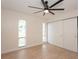 Well-lit bedroom with ceiling fan and sliding door closet at 2932 Carriage Dr, Daytona Beach, FL 32119