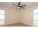 Bright bedroom featuring ceiling fan, light wood floors, and large windows at 2932 Carriage Dr, Daytona Beach, FL 32119