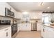 Modern kitchen with stainless steel appliances and white shaker cabinets at 2932 Carriage Dr, Daytona Beach, FL 32119