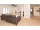 Open living space with a brown leather couch and kitchen view at 2932 Carriage Dr, Daytona Beach, FL 32119