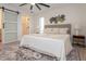 Main bedroom with king bed, barn door to bathroom, and ceiling fan at 2932 Carriage Dr, Daytona Beach, FL 32119