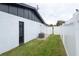 Side yard with access gate and air conditioning unit at 2932 Carriage Dr, Daytona Beach, FL 32119