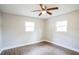 Spacious bedroom with two windows and ceiling fan at 308 Wade Ave, Deland, FL 32724