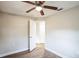 Well-lit bedroom with wood-look floors and access to hallway at 308 Wade Ave, Deland, FL 32724