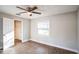 Bedroom with wood-look floors, window, and access to hallway at 308 Wade Ave, Deland, FL 32724