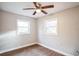 Bright bedroom with wood-look floors and two windows at 308 Wade Ave, Deland, FL 32724