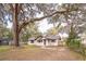 House with a large front yard, featuring mature oak trees with Spanish moss at 308 Wade Ave, Deland, FL 32724