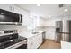 Modern kitchen featuring white shaker cabinets, stainless steel appliances, and quartz countertops at 308 Wade Ave, Deland, FL 32724