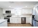 Modern kitchen featuring white shaker cabinets, stainless steel appliances, and quartz countertops at 308 Wade Ave, Deland, FL 32724