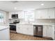 Modern kitchen featuring white shaker cabinets, stainless steel appliances, and quartz countertops at 308 Wade Ave, Deland, FL 32724