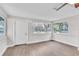 Bright living room, featuring wood-look floors and large windows at 308 Wade Ave, Deland, FL 32724