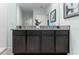 Double vanity bathroom with granite countertop and dark brown cabinets at 316 Corso Loop, Winter Haven, FL 33884