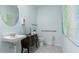 Small bathroom with pedestal sink, toilet, and decorative artwork at 316 Corso Loop, Winter Haven, FL 33884