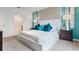 Spacious primary bedroom with plush bed and en-suite bathroom access at 316 Corso Loop, Winter Haven, FL 33884
