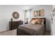 Bedroom with dark brown dresser and bedding, featuring artwork above the bed at 316 Corso Loop, Winter Haven, FL 33884
